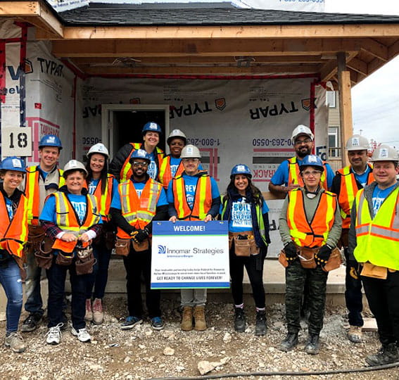 Innomar team holds sign at Habitat for Humanity 2019 build