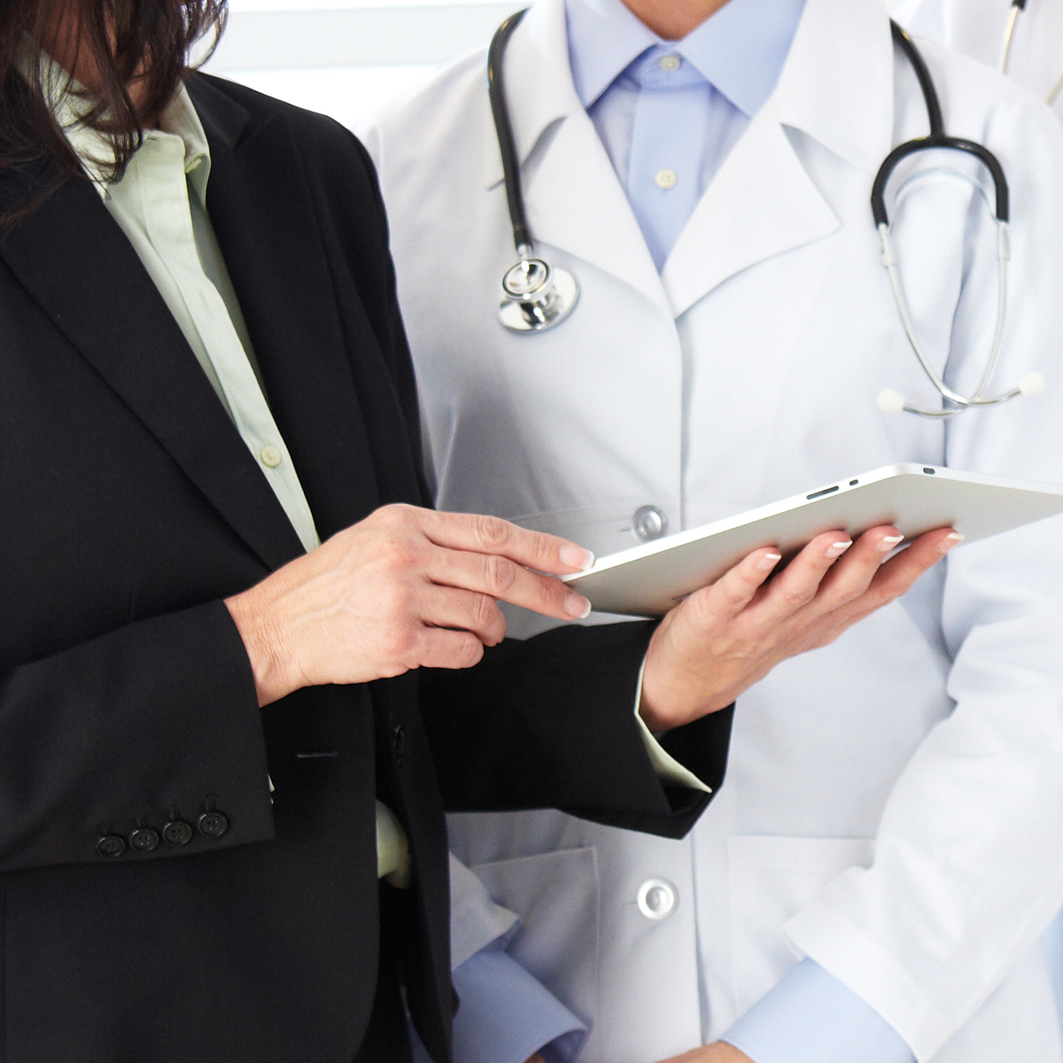 Business woman standing beside healthcare worker