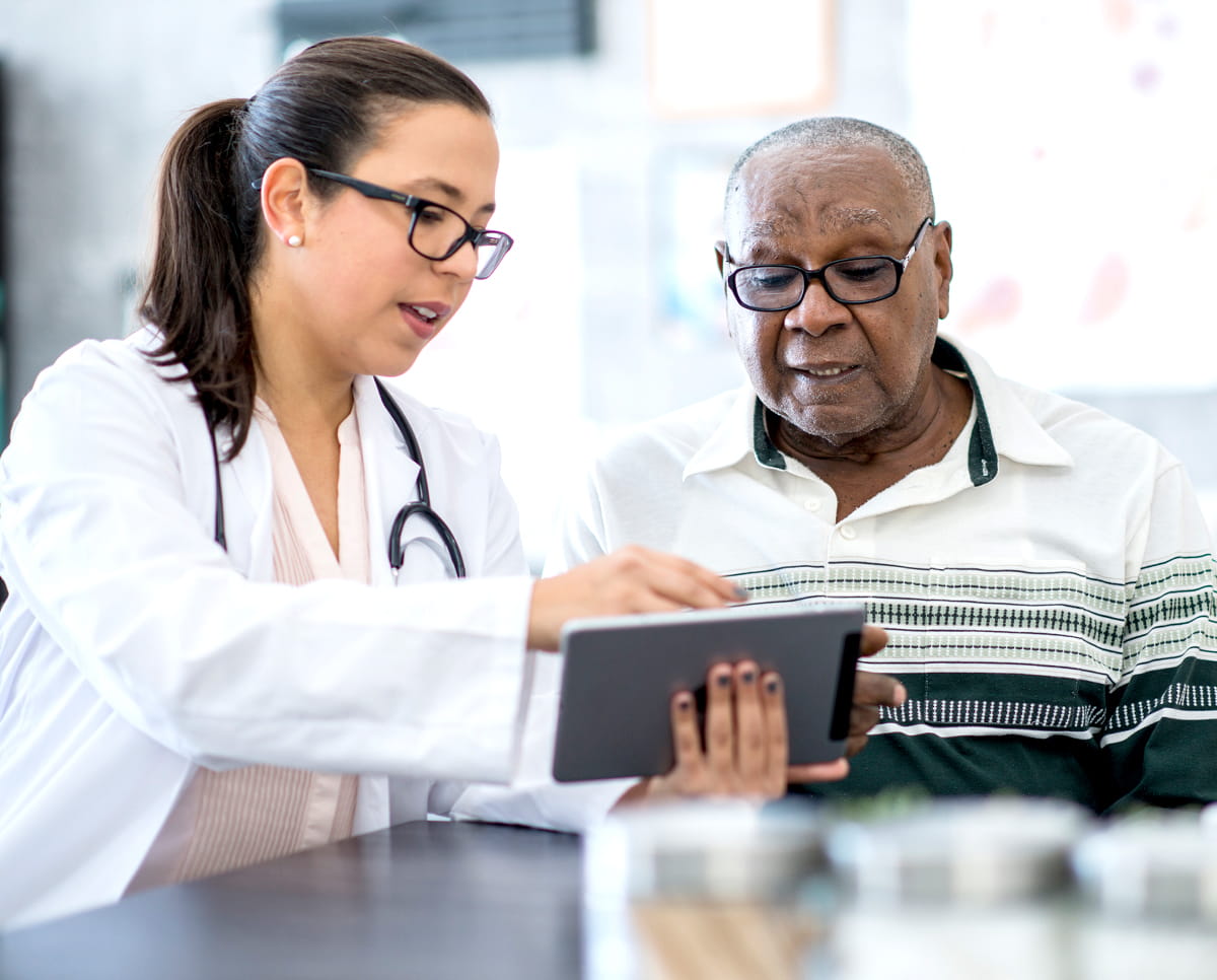 doctor on ipad with patient