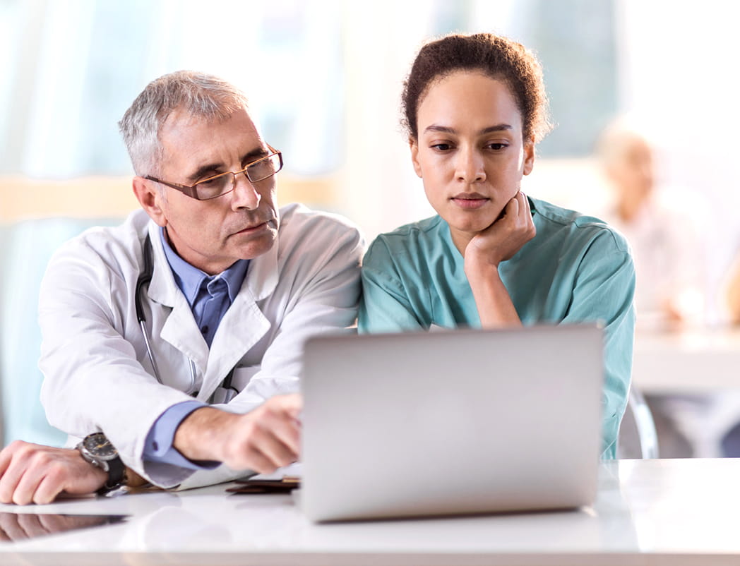 physician and nurse using laptop