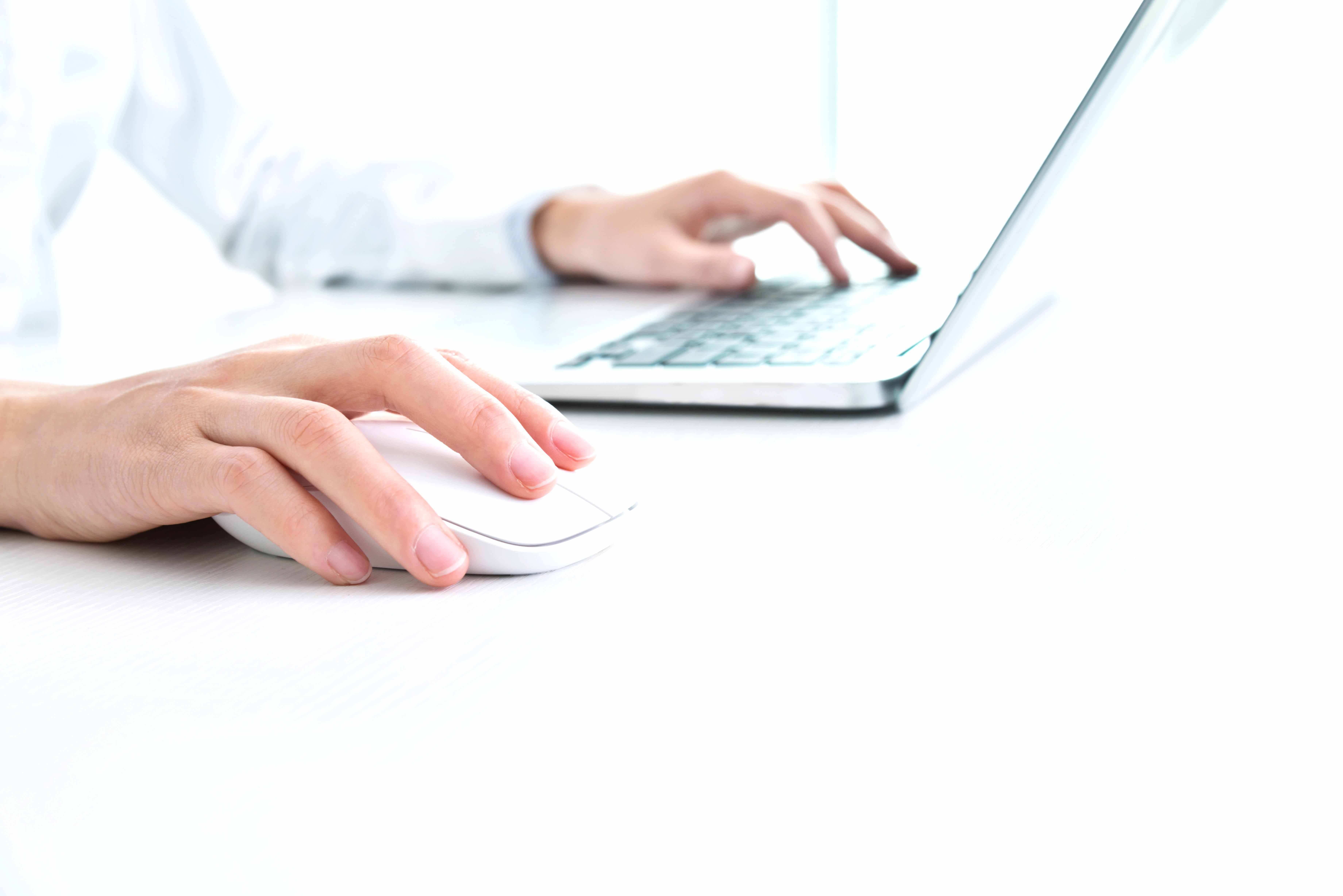 Person sitting in front of a laptop.