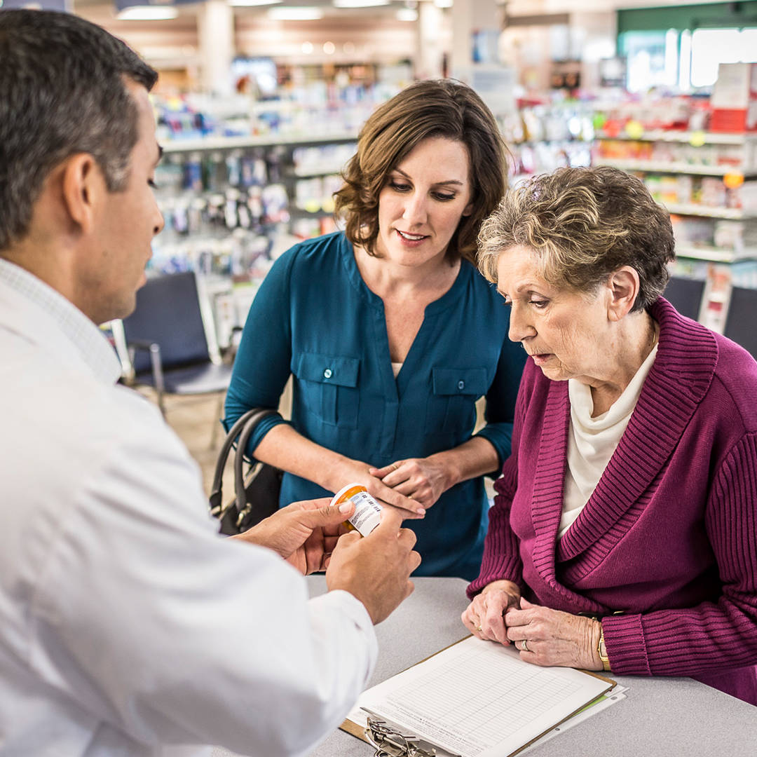 Pharmacist consults with senior mother and daughter