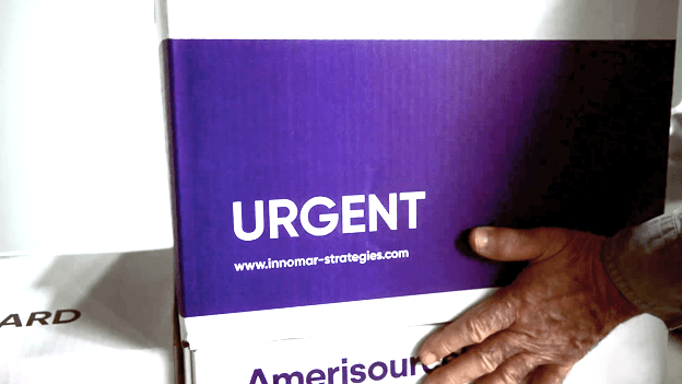 A box that has an Urgent label with vaccine doses ready for distribution.